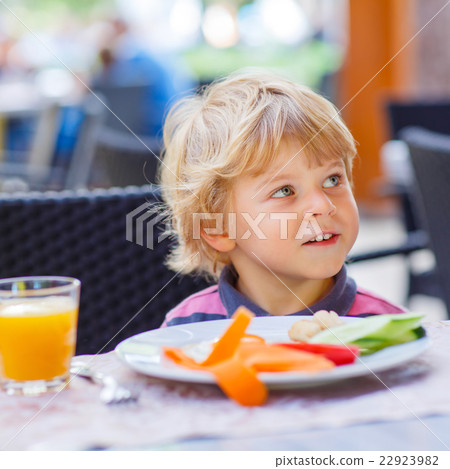 Little kid boy having healthy breakfast in 22923982