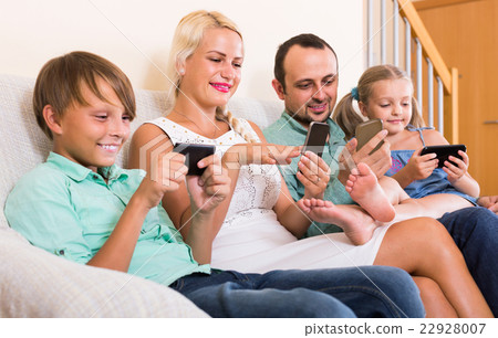 Portrait of  family playing with gadgets at home 22928007