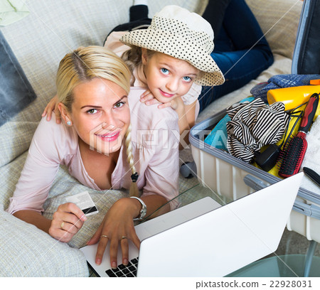 Family of two buying tickets online. 22928031