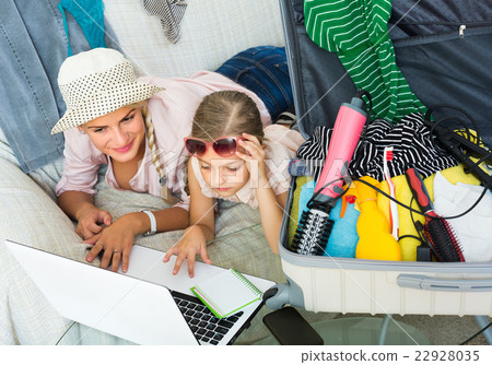 Woman with daughter planning vacation. 22928035