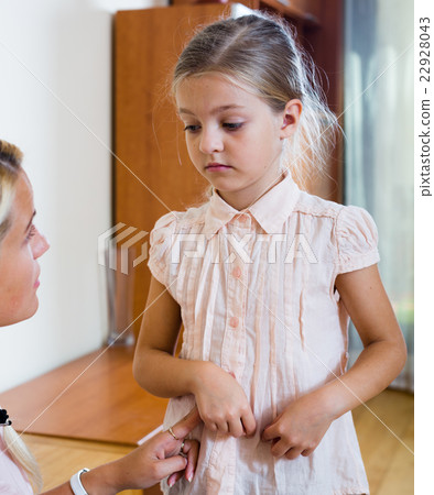 Sick girl with pain in stomach and worried mother indoors 22928043