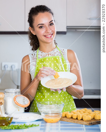 girl preparing croquettes for tasty dinner girl preparing croquettes for tasty dinner 22928370