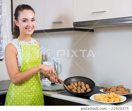 woman frying filled croquettes woman frying filled croquettes 22928375