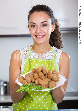 girl with tasty breadcrumbed crocchette girl with tasty breadcrumbed crocchette 22928379