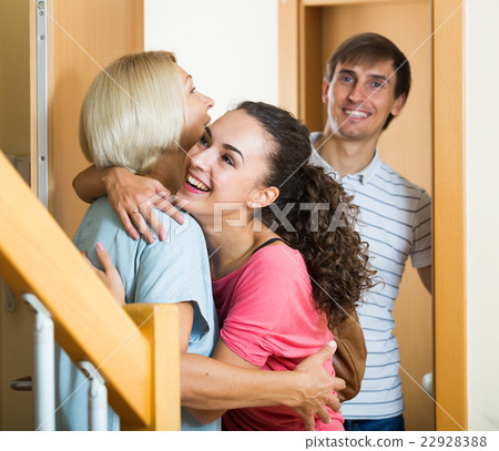 Cheerful senior woman greeting adult children coming with visit 22928388