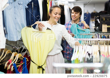 Couple choosing clothes in the mall Couple choosing clothes in the mall 22928875