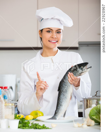 Young chef holding carcass of fish Young chef holding carcass of fish 22928967