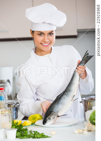 Young chef holding carcass of rainbow trout Young chef holding carcass of rainbow trout 22928968