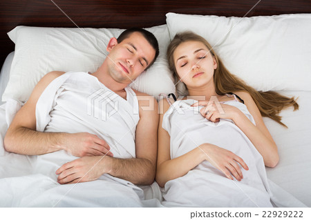 Portrait of adult couple napping in bed Portrait of adult couple napping in bed 22929222