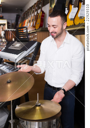Male buyer selecting drums and accessories Male buyer selecting drums and accessories 22929310