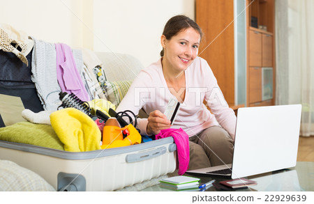 brunette packing luggage 22929639
