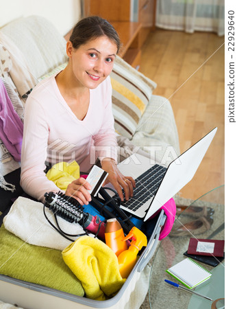 brunette packing luggage brunette packing luggage 22929640