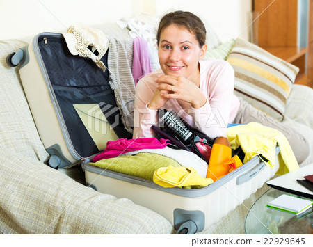 Woman with packed baggage and notes 22929645