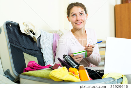 Woman with packed baggage and notes 22929646