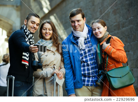 Group of friends shooting mutual portrait on cell phone 22929696