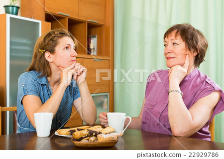 Mother and daughter drinking tea Mother and daughter drinking tea 22929786