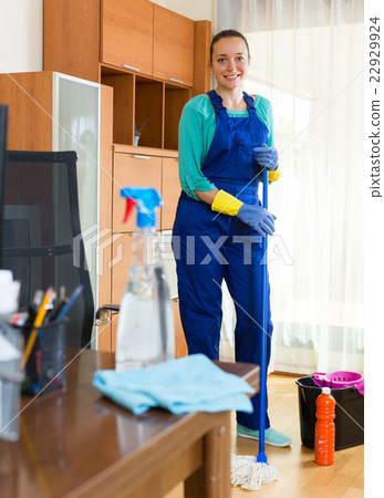Woman cleaning office room. 22929924