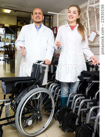 Man and young woman with mechanical wheelchairs Man and young woman with mechanical wheelchairs 22930198