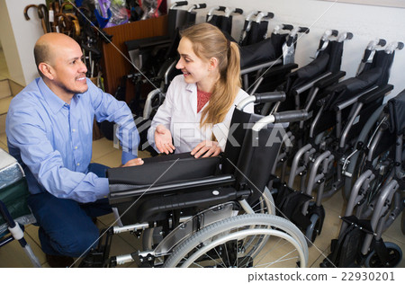 Specialist consulting client about wheelchairs Specialist consulting client about wheelchairs 22930201