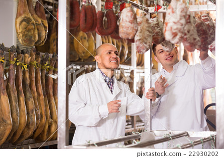 Technologist with butcher checking jamon 22930202