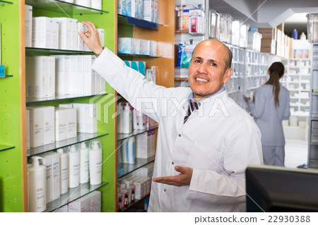 Male pharmacist in drugstore. Male pharmacist in drugstore. 22930388