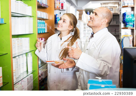 Two pharmacists in chemist shop 22930389