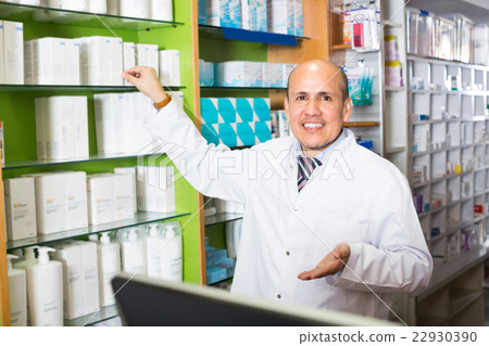 Male pharmacist in drugstore. 22930390