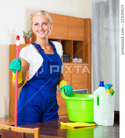 Young maid cleaning at apartment. 22930625