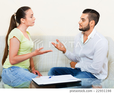 Serious male and female sitting 22931198