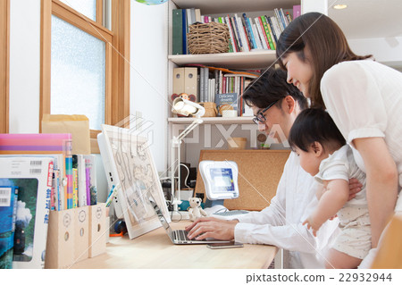 A young family watching a computer at the study 22932944