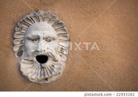 Sculpture of a face with open mouth 22933162