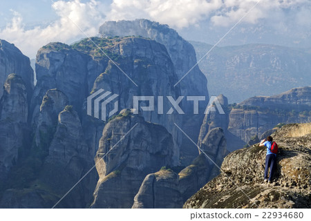 A tourist standing at the edge of the cliff A tourist standing at the edge of the cliff 22934680