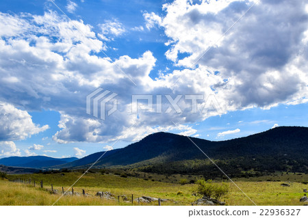 Rural landscape with mountains & overcast blue sky 22936327