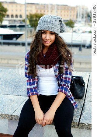 Young attractive young woman sitting outside 22938406