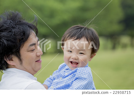A boy laughing in a father in a park 22938715