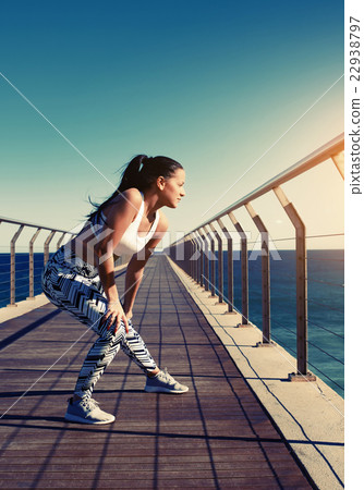 Female runner warming up before a workout  22938797