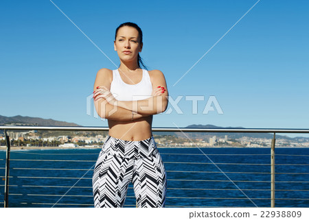 Female runner taking break while standing outside 22938809