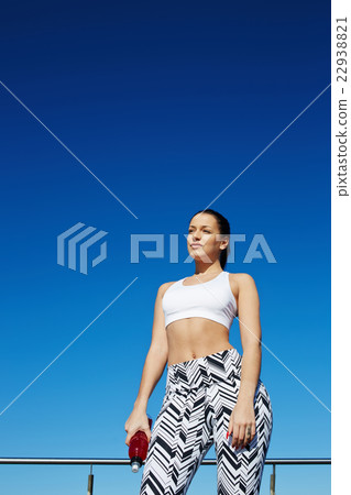 Fit woman with beautiful figure standing outdoors 22938821