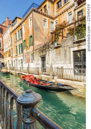 Lovely canal with gondola in Venice 22940424