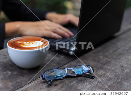 A man with laptop computer in cafe shop 22942697