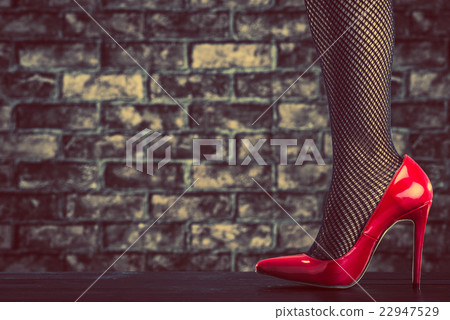 A woman wearing a red high heel 22947529