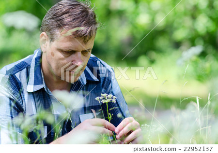 Melancholic man ponders problem during nature walk 22952137