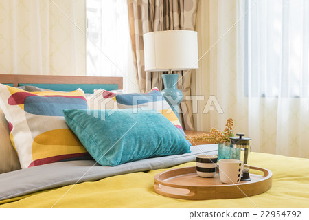 colorful pillows on wooden bed in modern bedroom 22954792