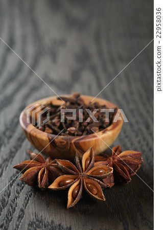 anise stars and cloves on oak table 22958036
