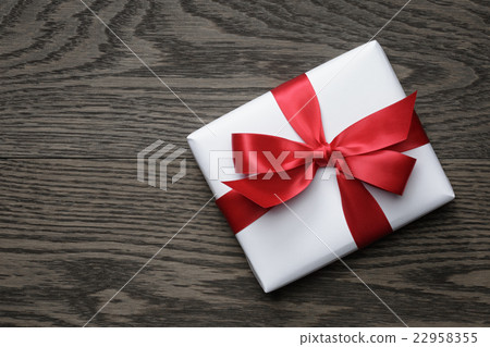 gift box with red bow on wood table gift box with red bow on wood table 22958355