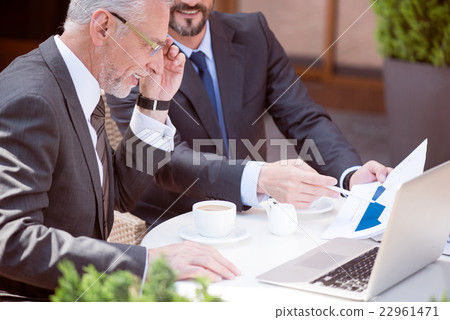 Cheerful colleagues sitting at the table 22961471