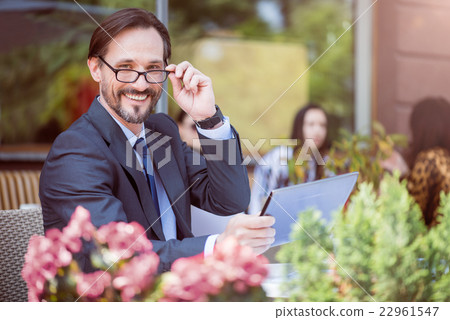 Cheerful man sitting in the cafe Cheerful man sitting in the cafe 22961547