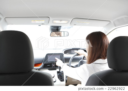 A young lady manipulating car navigation A young lady manipulating car navigation 22962922
