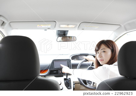 A young lady manipulating car navigation A young lady manipulating car navigation 22962923