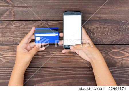 closeup hand use phone and credit card on table 22963174